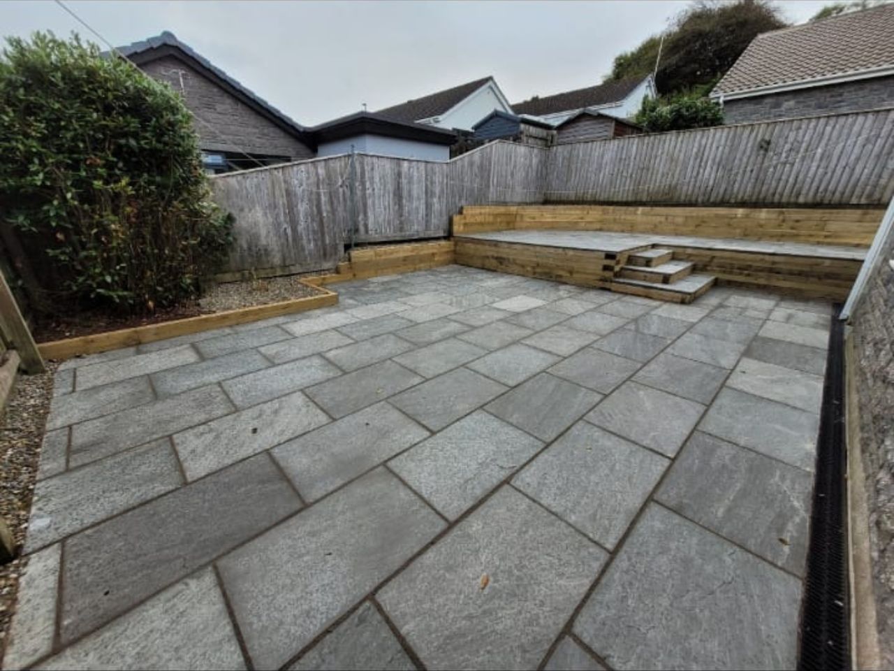 Grey sandstone patio with sleeper terracing and steps