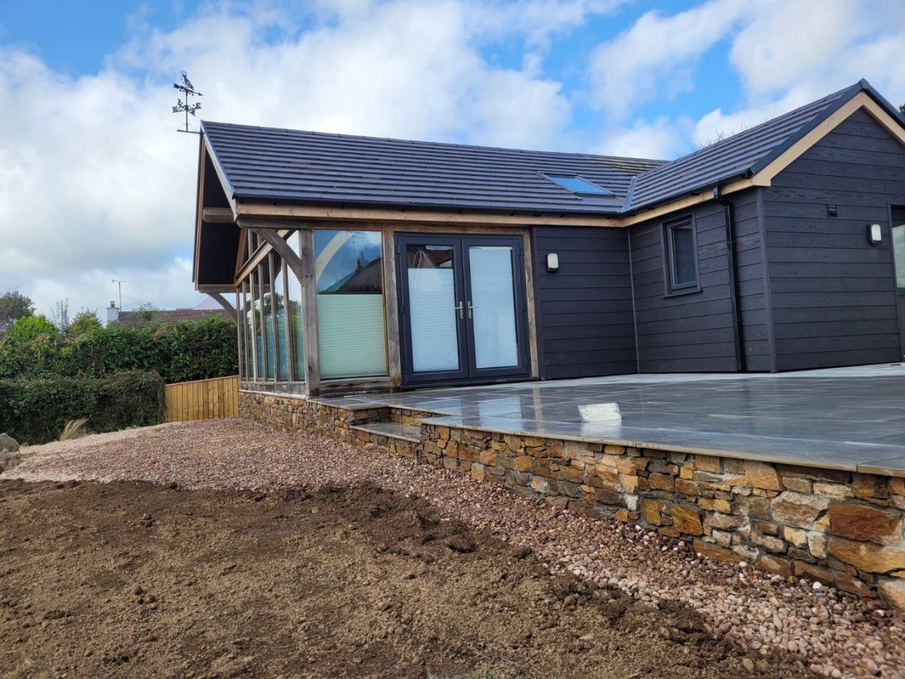 Grey porcelain patio with timber sleeper steps