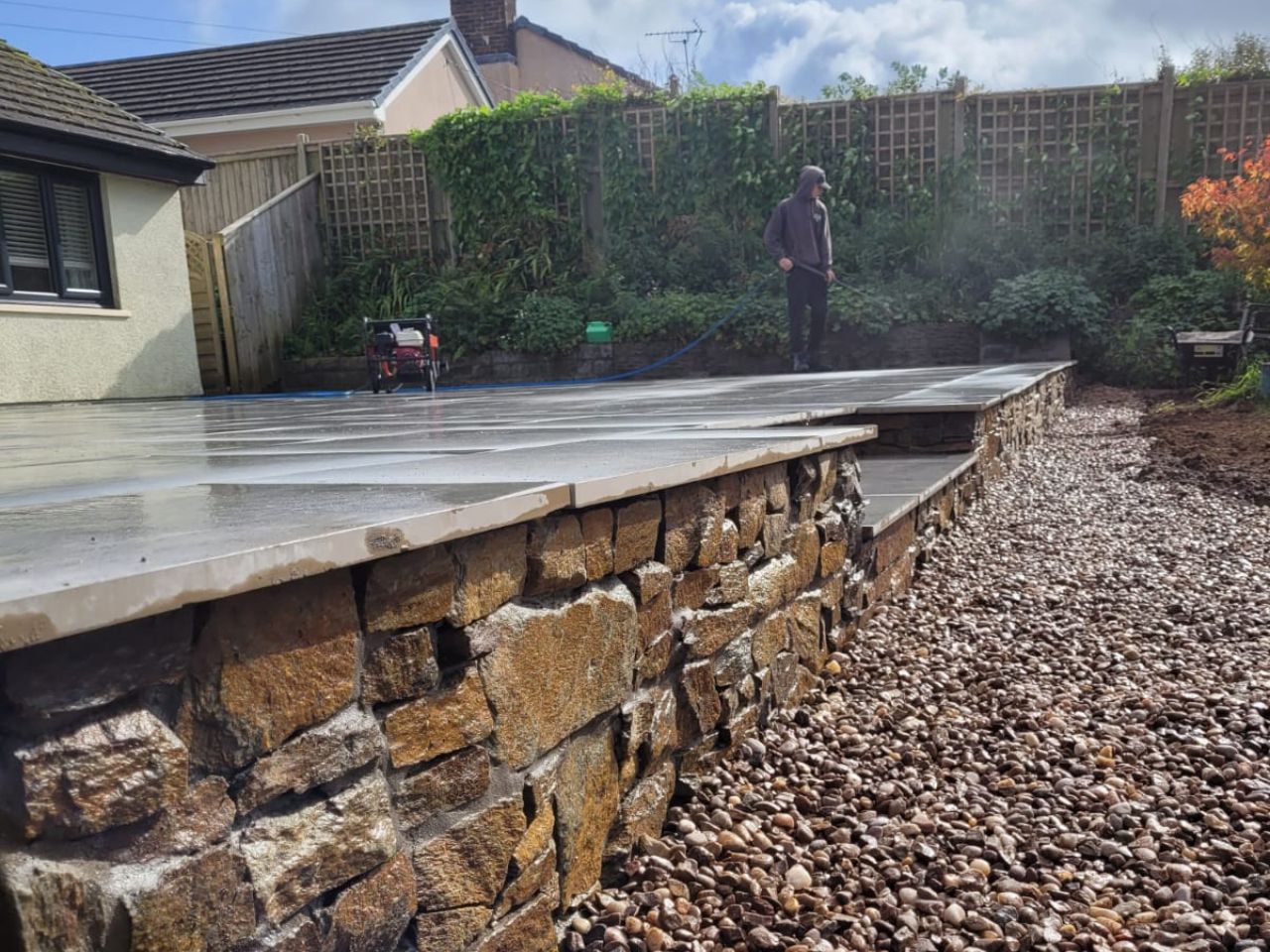 Stone retaining wall and paving under construction