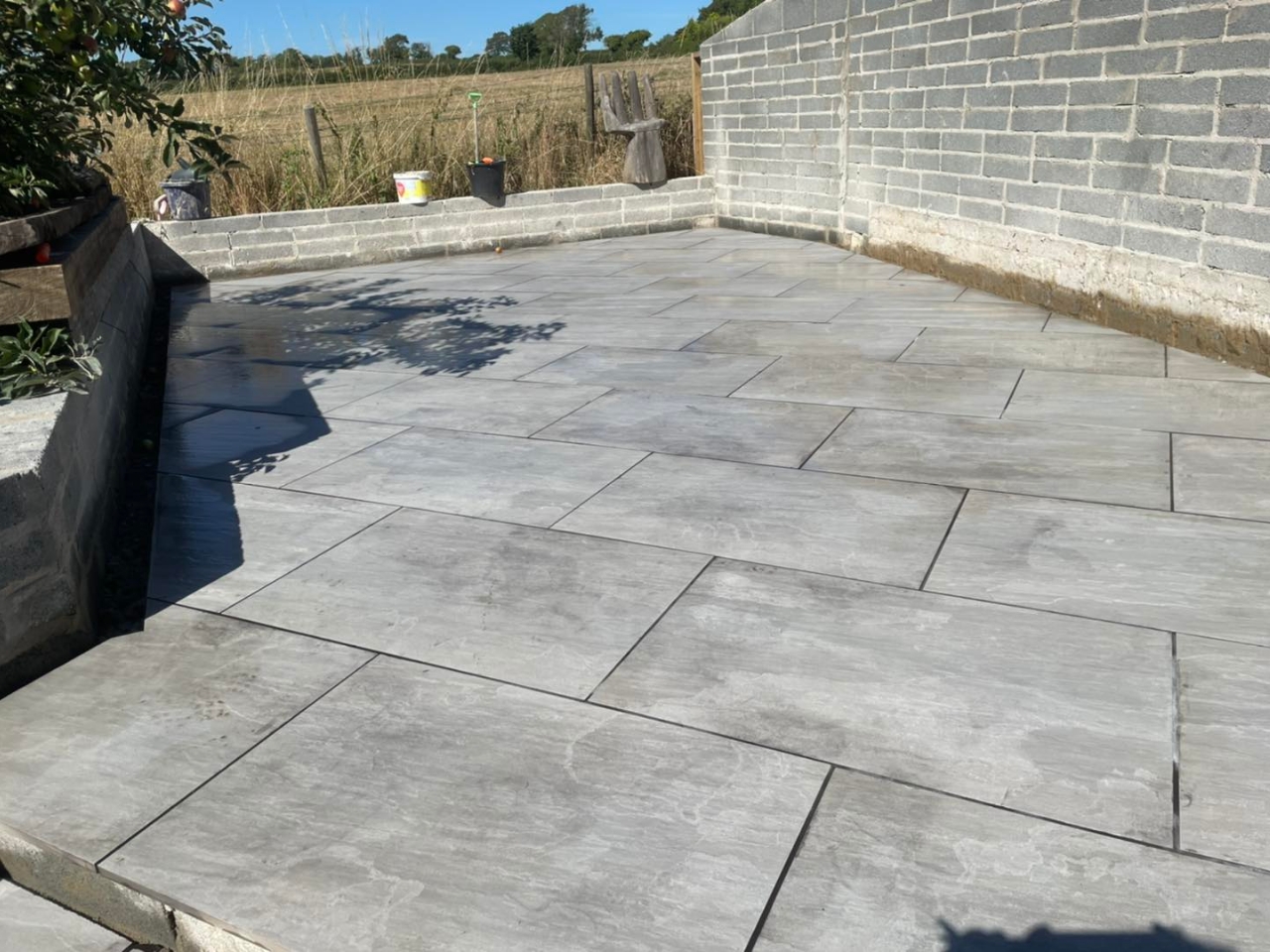 Grey porcelain patio with block walling and countryside views