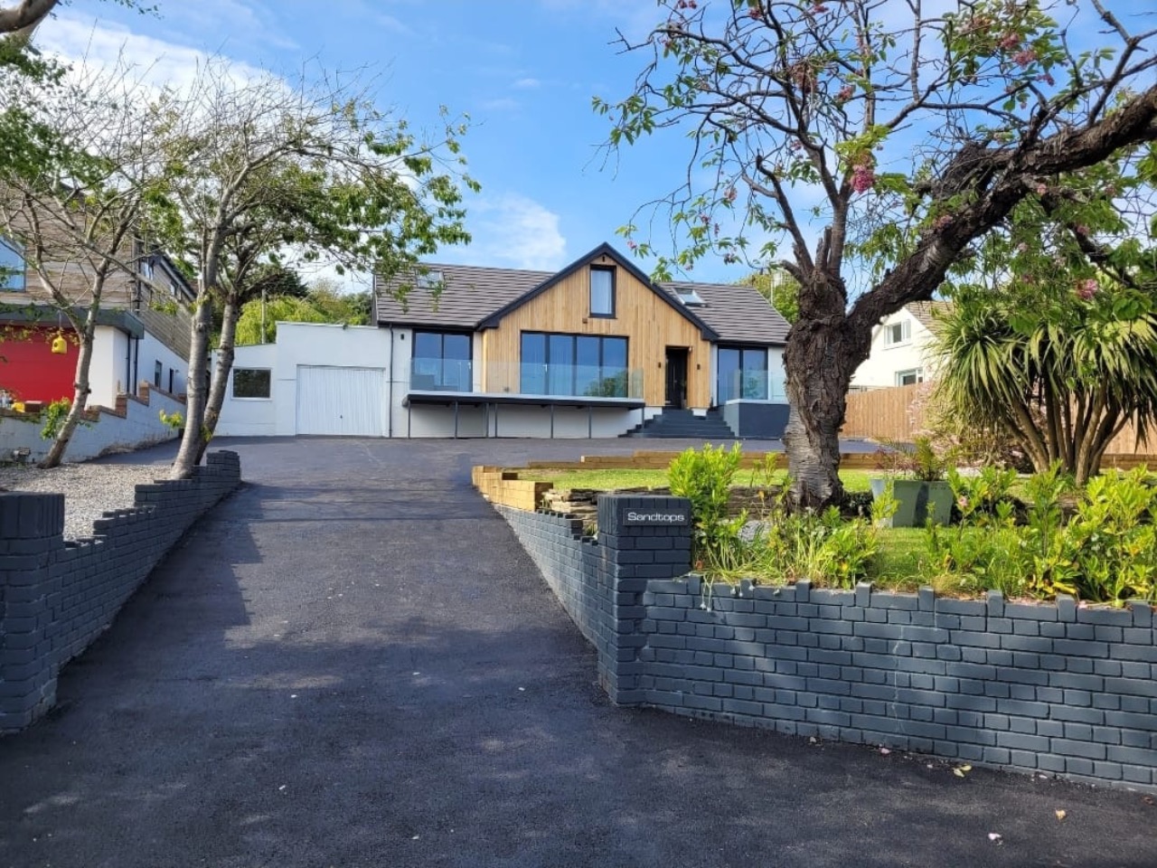 Tarmac driveway with grey brick walls at a modern Pembrokeshire house
