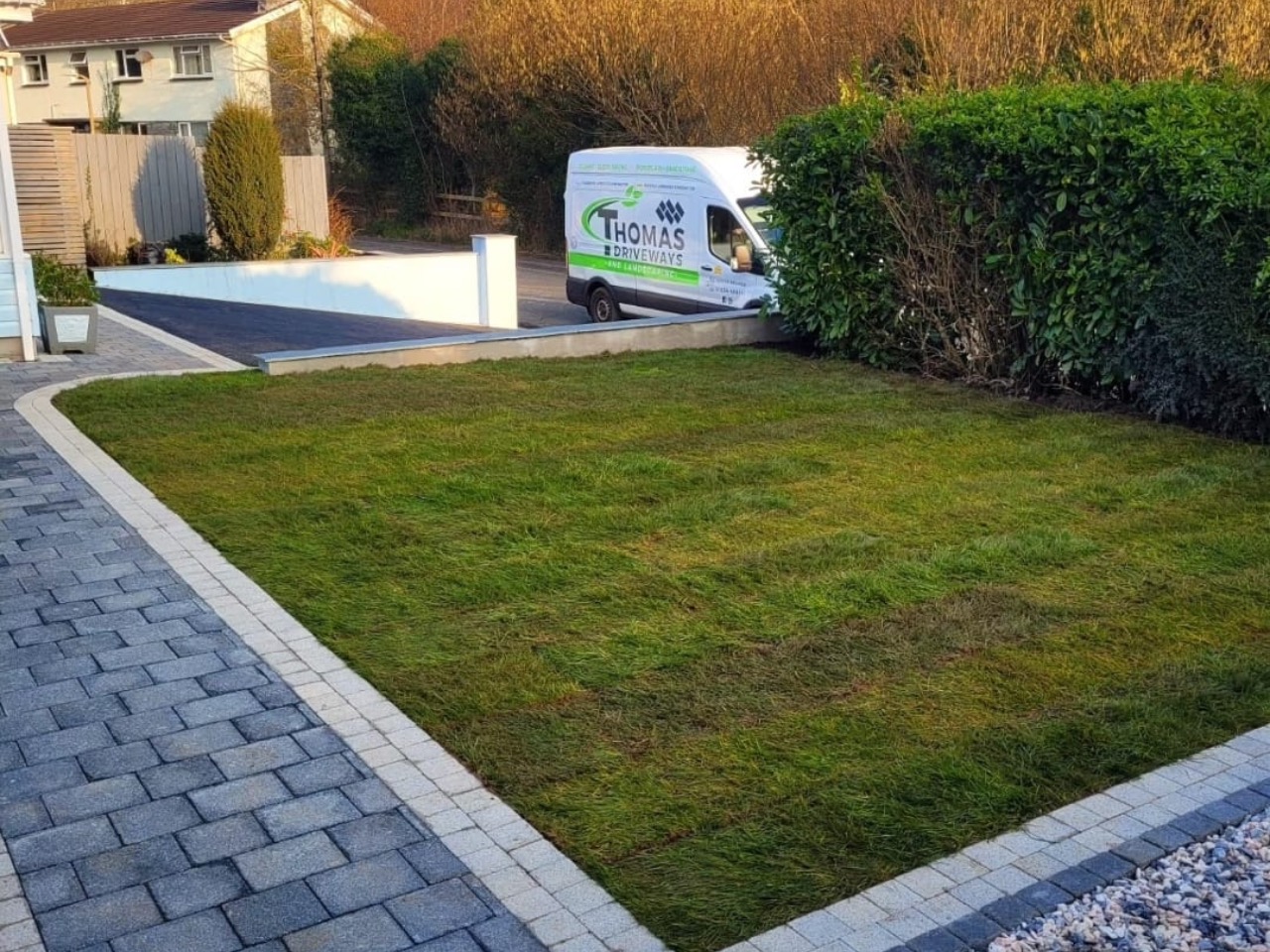 Thomas Driveways branded van beside new block paving